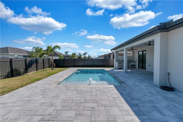 view of pool with pool water feature, a patio, and ceiling fan