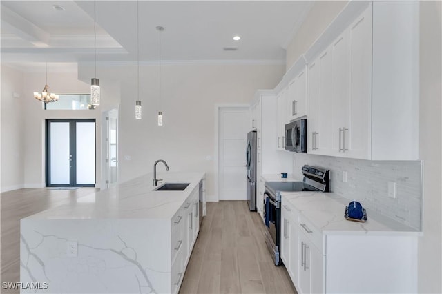 kitchen featuring white cabinets, sink, hanging light fixtures, light stone countertops, and appliances with stainless steel finishes