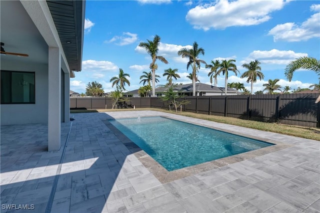 view of swimming pool with a patio and ceiling fan