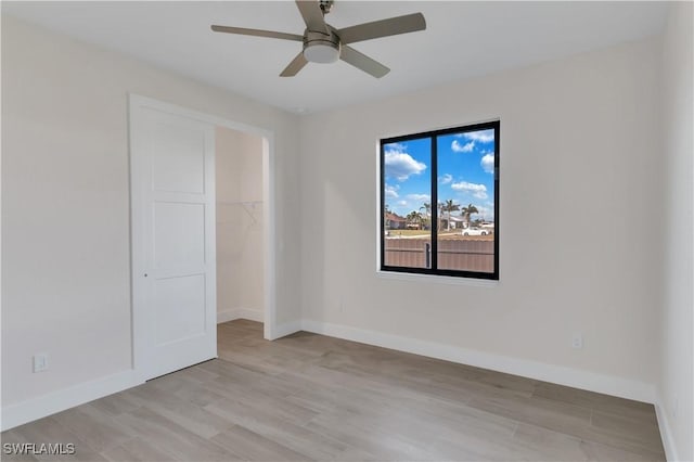 spare room with ceiling fan and light hardwood / wood-style flooring