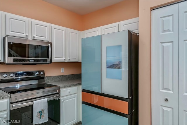 kitchen with stainless steel appliances and white cabinets