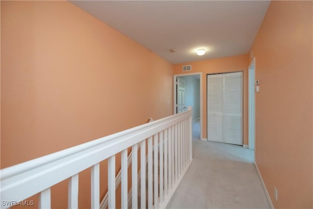 hallway with light colored carpet