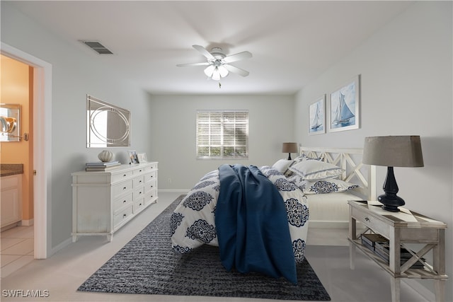 bedroom featuring connected bathroom, ceiling fan, and light colored carpet