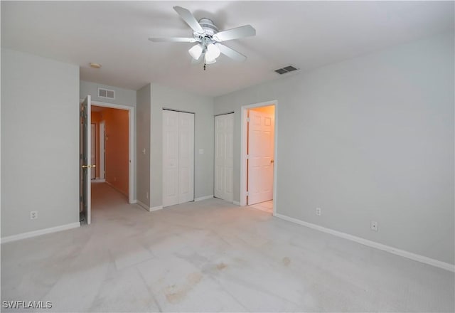 unfurnished bedroom featuring light carpet and ceiling fan