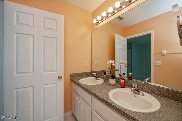 bathroom featuring tile patterned flooring and vanity