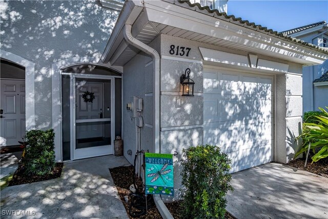 view of exterior entry featuring a garage