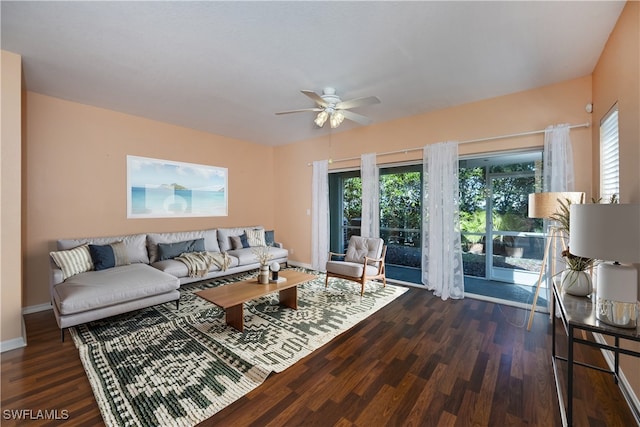 living room with dark wood-type flooring and ceiling fan