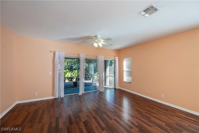 unfurnished room featuring dark wood-type flooring and ceiling fan