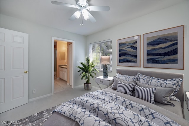 carpeted bedroom with ceiling fan and ensuite bath