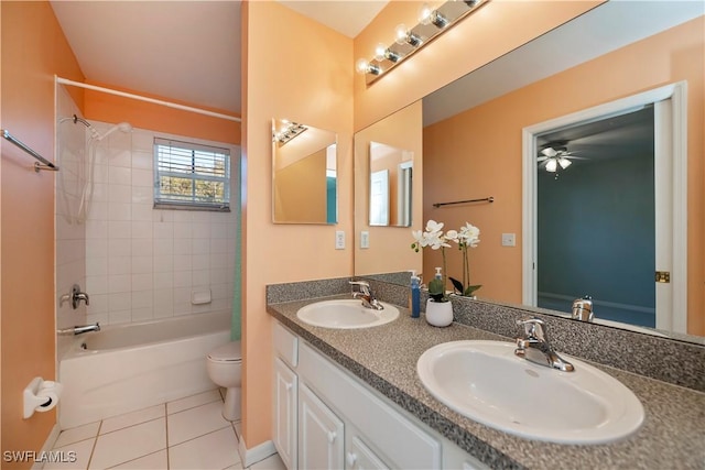 full bathroom with toilet, tile patterned floors, tiled shower / bath combo, ceiling fan, and vanity