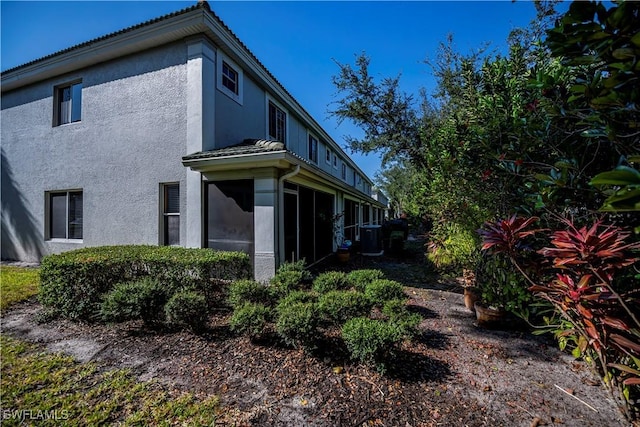 view of side of property featuring a sunroom