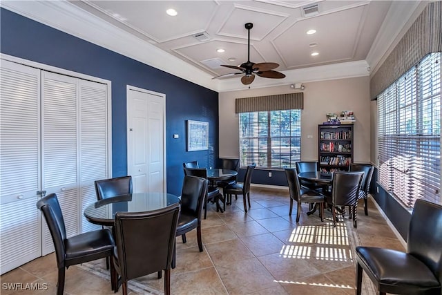 tiled dining space with ceiling fan, a healthy amount of sunlight, coffered ceiling, and ornamental molding