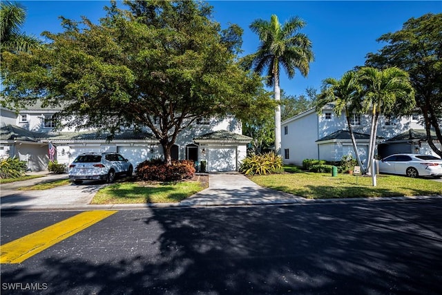 view of front of house featuring a front yard and a garage