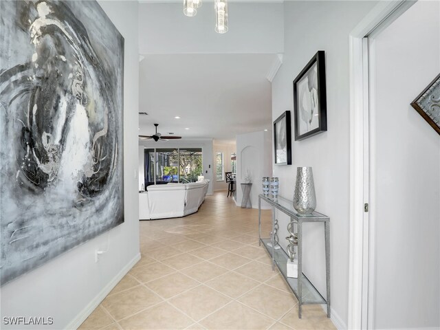 hallway featuring light tile patterned flooring and baseboards