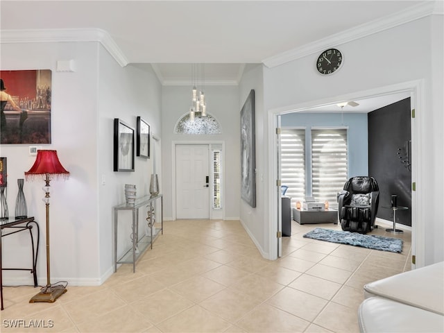 entrance foyer featuring crown molding, light tile patterned floors, and baseboards