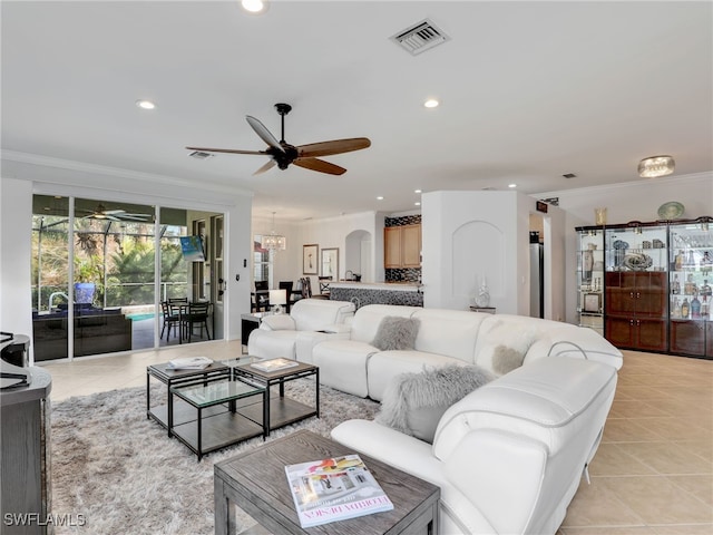 living area featuring light tile patterned floors, a ceiling fan, visible vents, recessed lighting, and ornamental molding