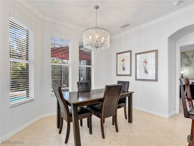 dining area with crown molding, baseboards, visible vents, and a chandelier