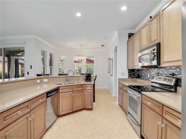 kitchen featuring a sink, appliances with stainless steel finishes, crown molding, light tile patterned floors, and decorative backsplash