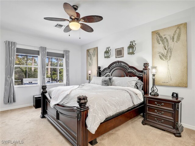 bedroom with a ceiling fan, baseboards, visible vents, and light carpet