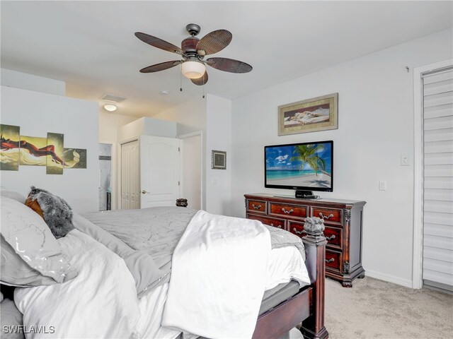 bedroom with visible vents, light colored carpet, baseboards, and a ceiling fan