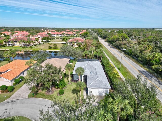 drone / aerial view with a residential view and a water view