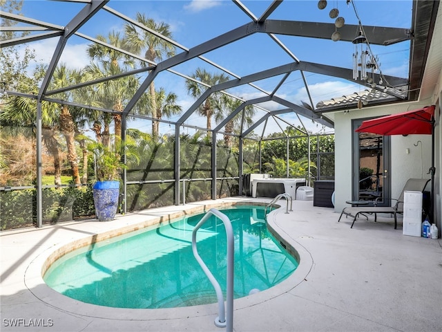 outdoor pool with glass enclosure and a patio