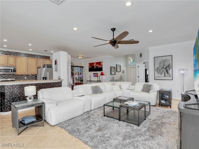 tiled living room with ornamental molding and ceiling fan