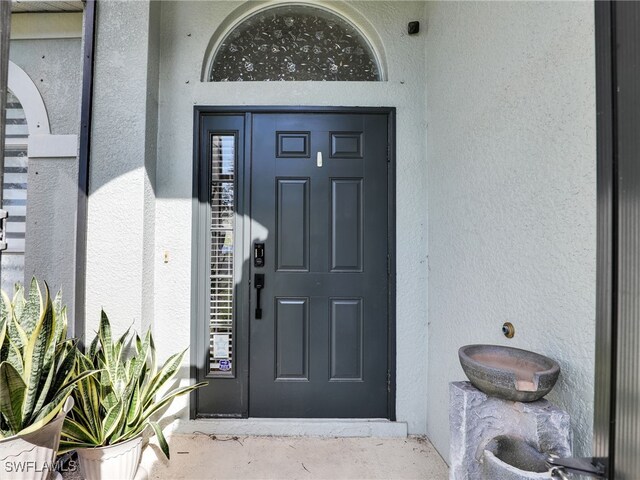 property entrance featuring stucco siding