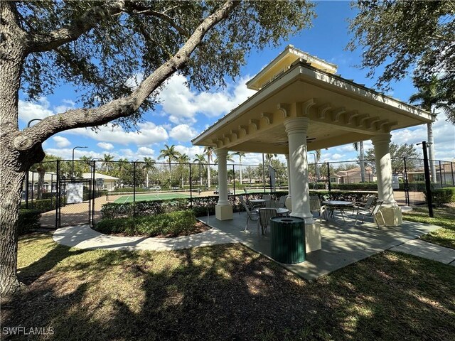 view of home's community featuring fence