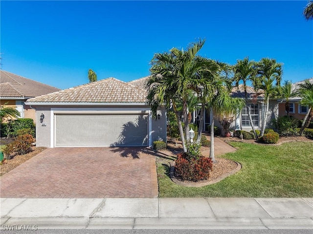 view of front of home with a front yard and a garage