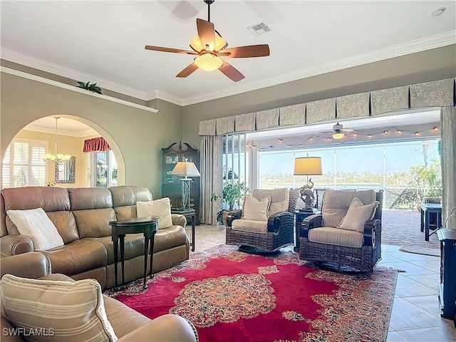 tiled living room featuring ceiling fan with notable chandelier, crown molding, and a wealth of natural light