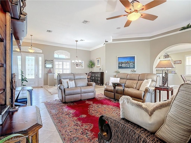 living room with ceiling fan with notable chandelier, light tile patterned flooring, and crown molding