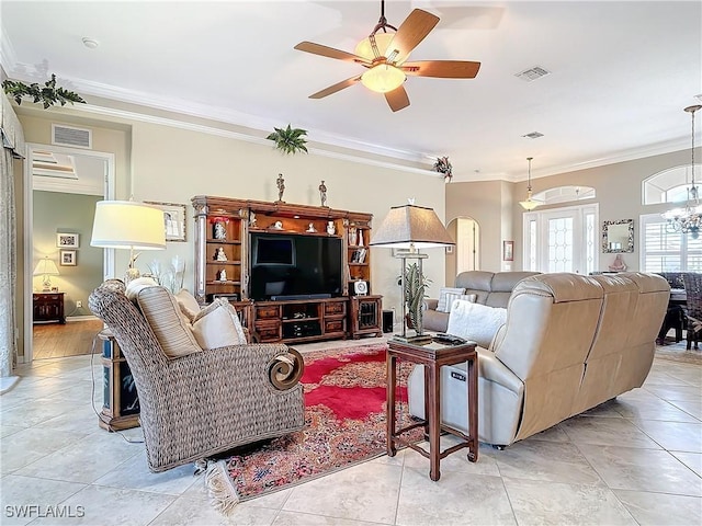 living room with crown molding, ceiling fan with notable chandelier, and light tile patterned floors