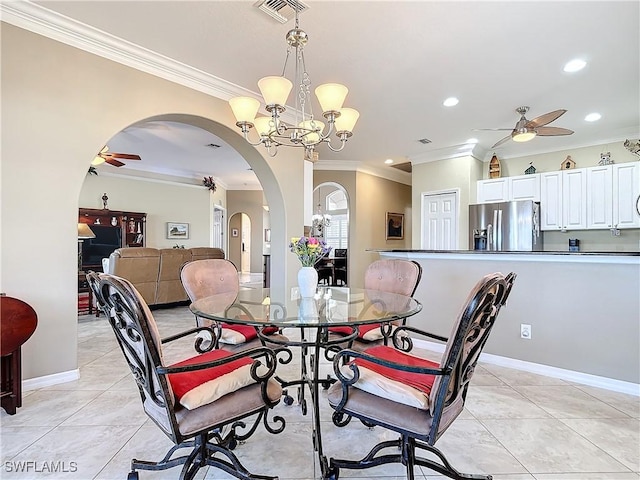 dining area featuring ceiling fan with notable chandelier, light tile patterned floors, and crown molding