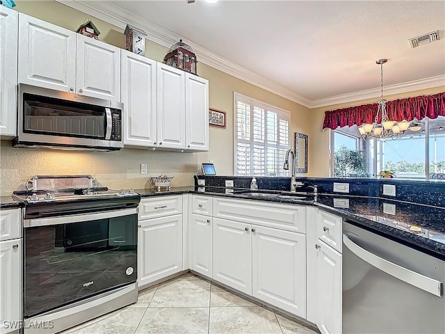 kitchen featuring appliances with stainless steel finishes, white cabinets, ornamental molding, and sink