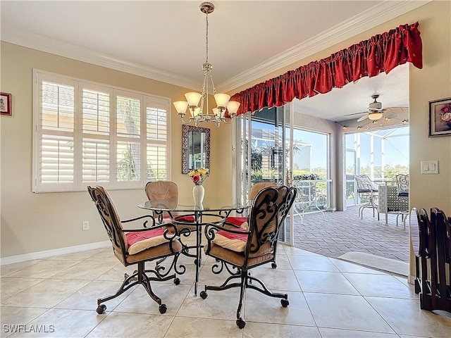 dining space with ornamental molding, ceiling fan with notable chandelier, and light tile patterned floors