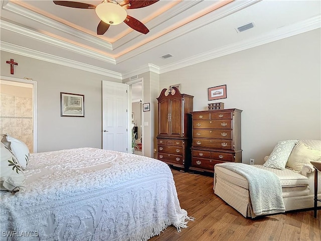 bedroom with ceiling fan, ornamental molding, ensuite bathroom, and hardwood / wood-style flooring