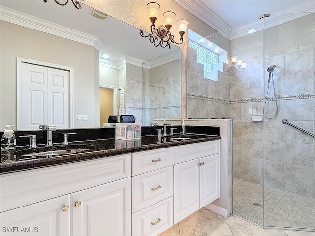 bathroom featuring tiled shower, ornamental molding, tile patterned floors, vanity, and a notable chandelier