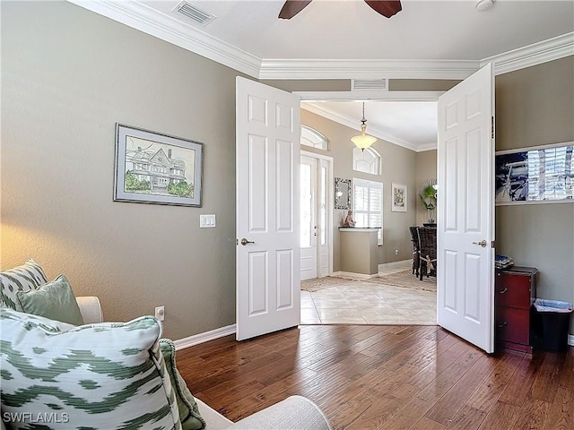 bedroom with ceiling fan, hardwood / wood-style floors, and crown molding