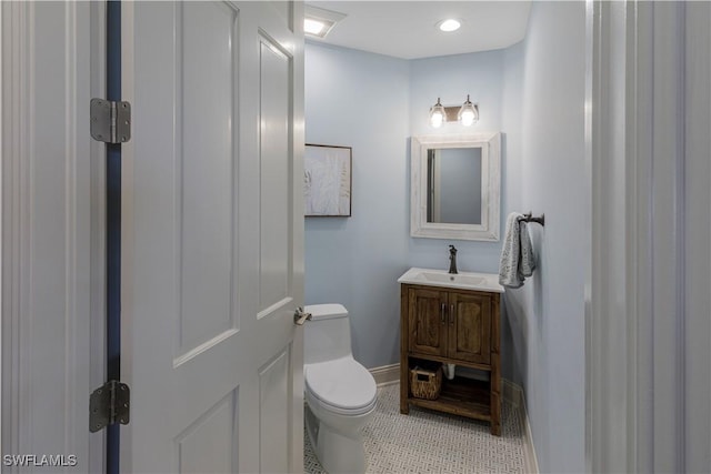 bathroom featuring tile patterned floors, vanity, and toilet