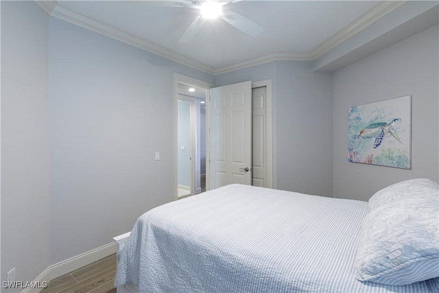 bedroom with hardwood / wood-style floors, ceiling fan, and crown molding