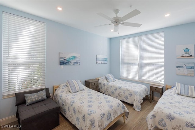 bedroom with ceiling fan and hardwood / wood-style floors