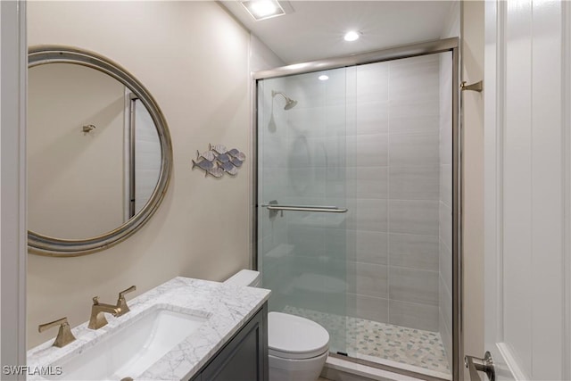 bathroom with vanity, an enclosed shower, and toilet