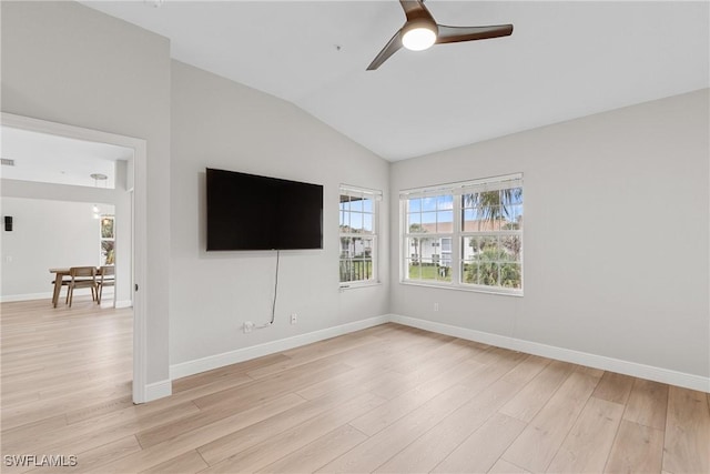 unfurnished room featuring ceiling fan, light hardwood / wood-style floors, and vaulted ceiling