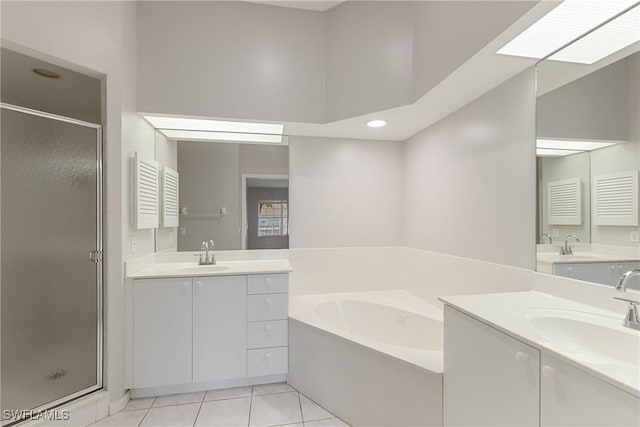 bathroom featuring tile patterned floors, plus walk in shower, and vanity