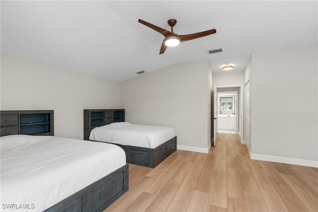 bedroom featuring ceiling fan, lofted ceiling, and light wood-type flooring