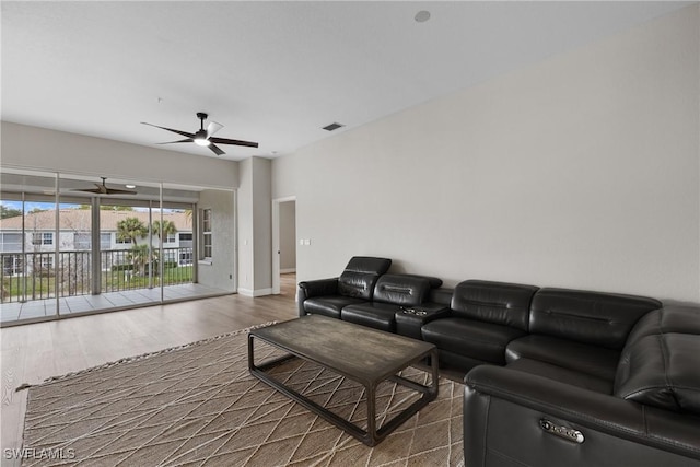 living room featuring ceiling fan and wood-type flooring