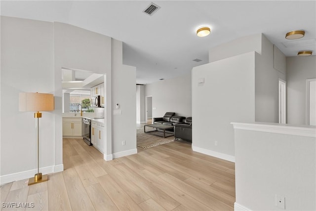 interior space featuring sink and light hardwood / wood-style floors