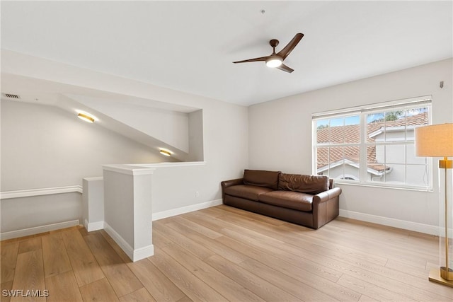 living area with ceiling fan and light hardwood / wood-style flooring