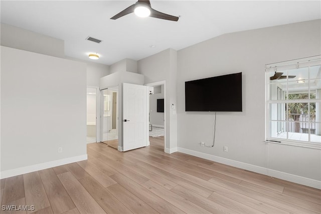 interior space featuring ceiling fan, lofted ceiling, light hardwood / wood-style floors, and ensuite bath